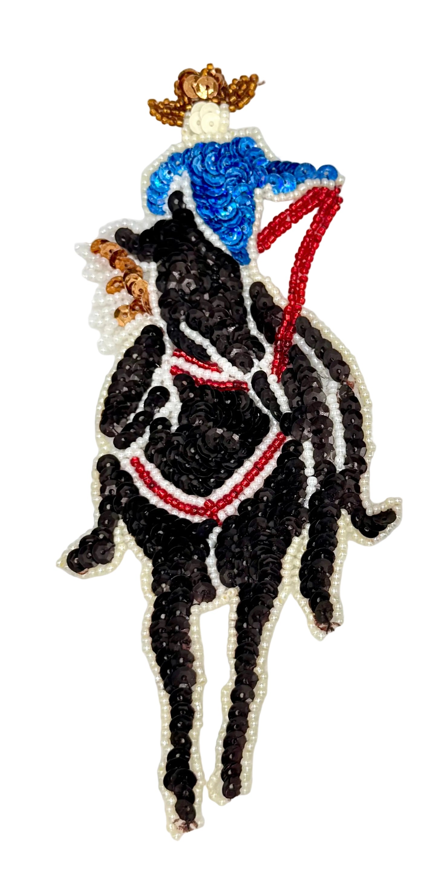 Sequin patch of a person on a horse with a blue hat and red reins on a white background