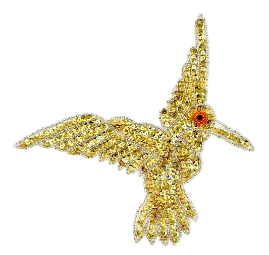 Gold hummingbird patch with sequins and beads on a white background