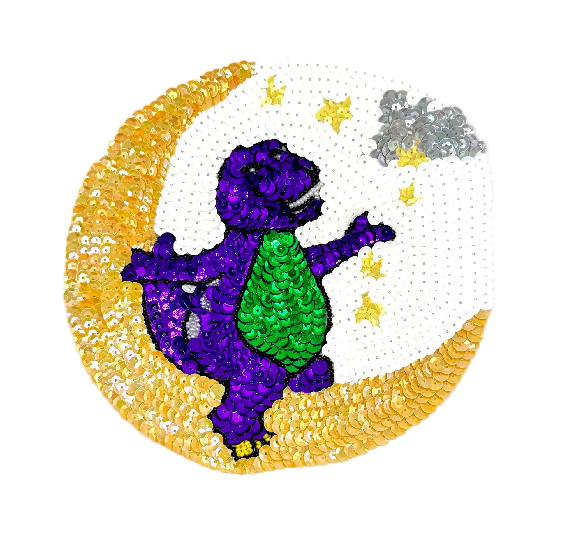 Sequined patch of a purple and green dinosaur on a gold crescent moon with stars.
