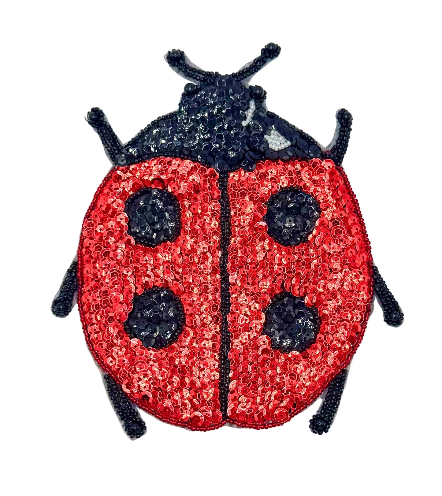 Sequined ladybug patch on a white background