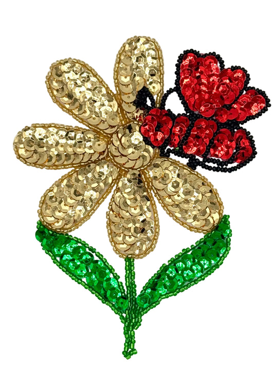 Decorative flower with gold sequin petals, red insect , and green leaves on a white background