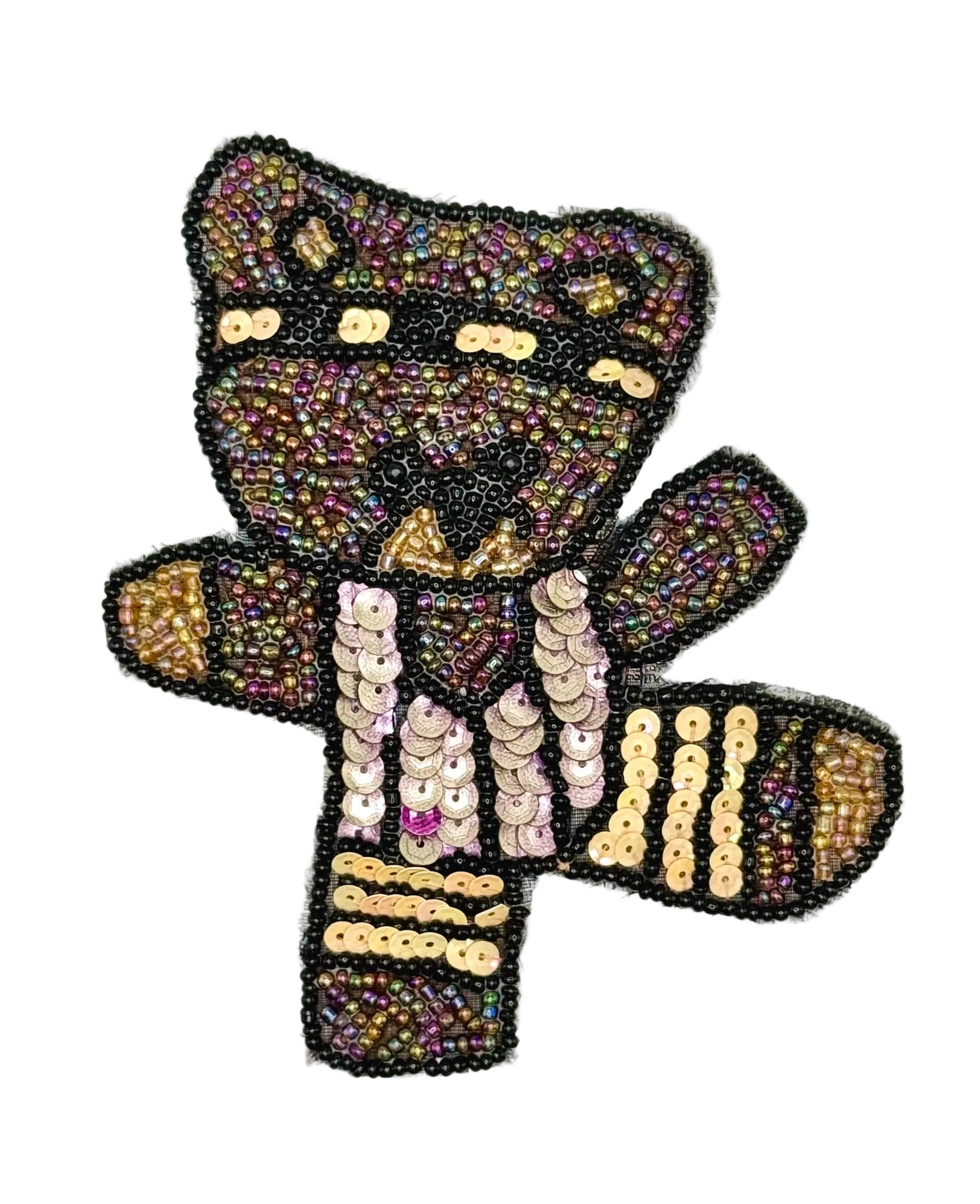 Decorative bear-shaped patch with sequins on a white background