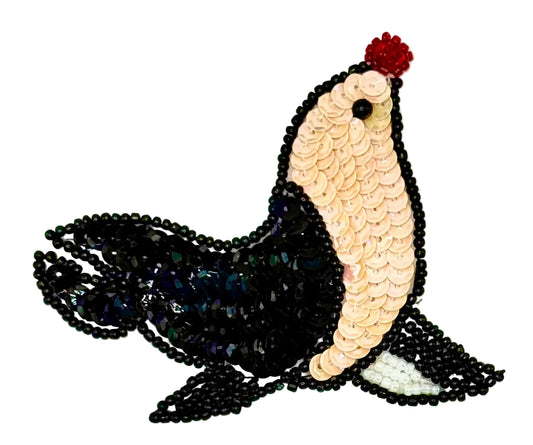  Sequin and bead seal patch with black and beige colors on a white background