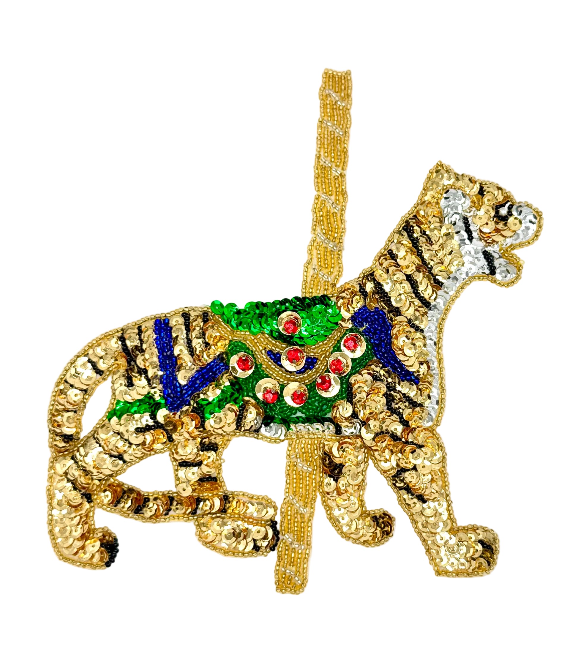 Decorative  sequin and bead tiger carousel animal with gold, green, and blue details on a white background