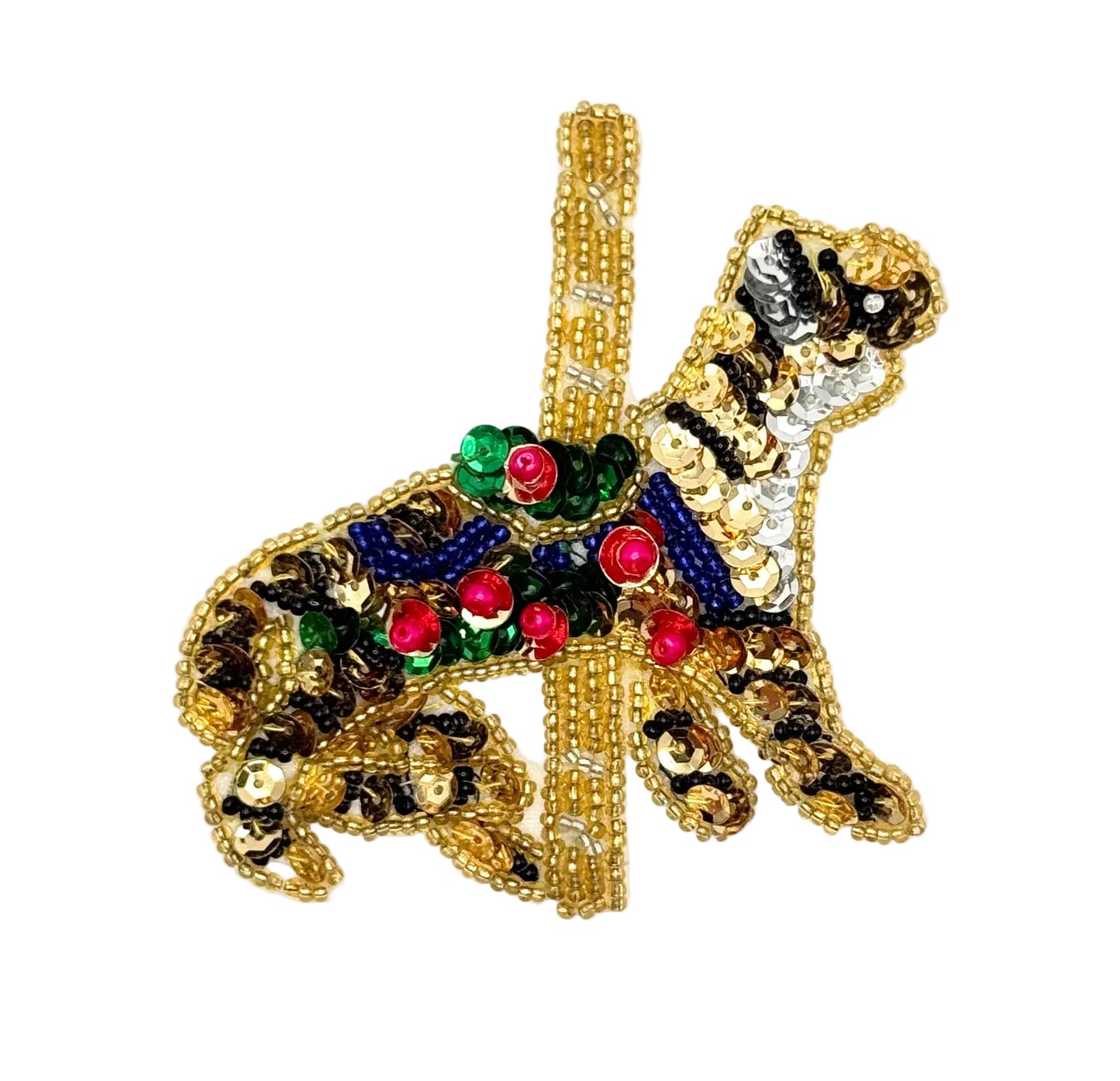 Decorative  sequin and bead tiger carousel animal with gold, green, and blue details on a white background