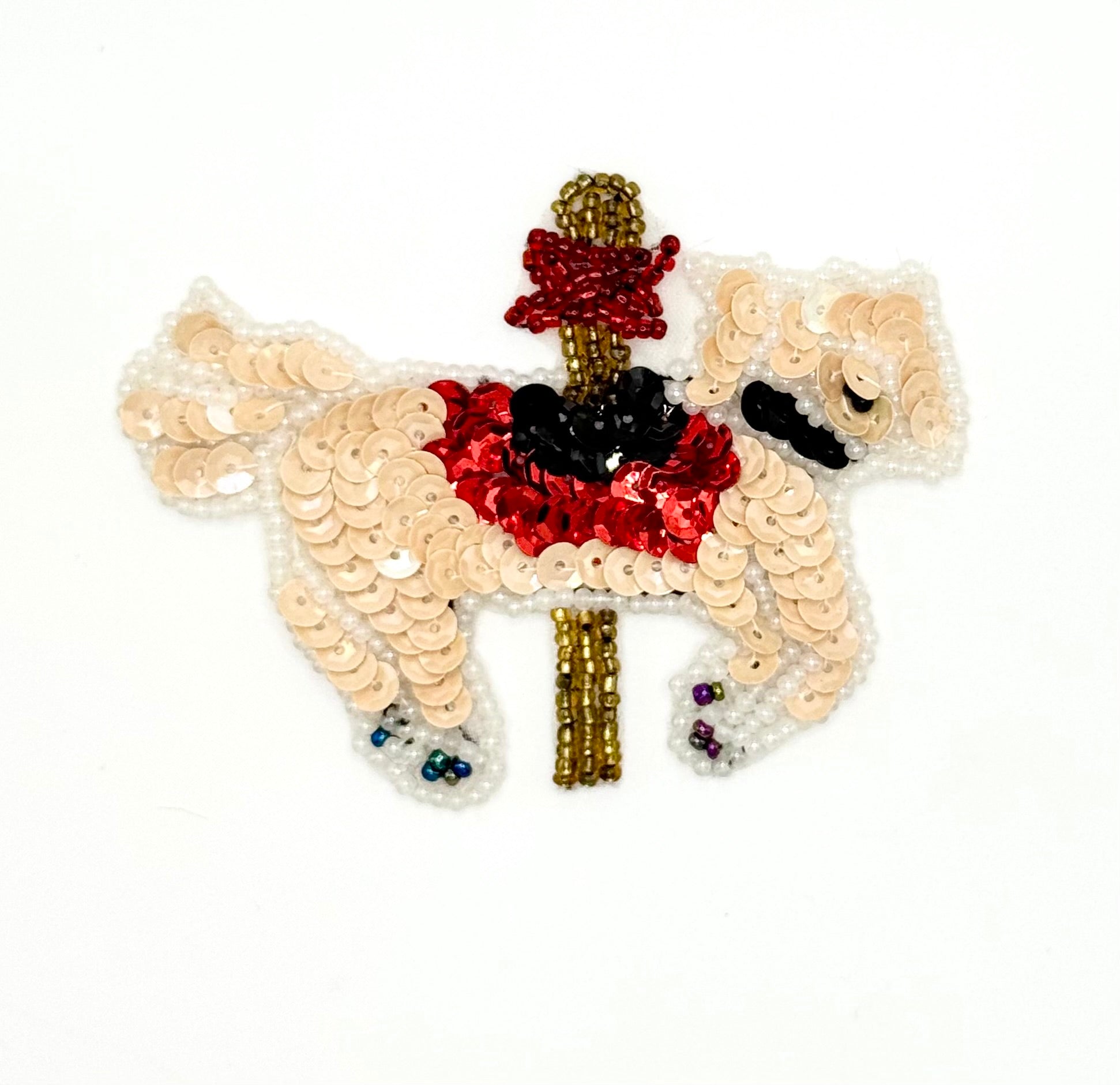 Sequined carousel horse with sequins and beads on a white background
