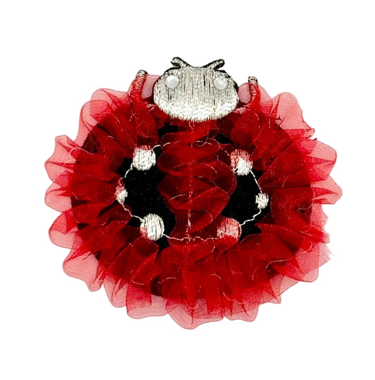 Embroidered lady bug patch with silver center on a white background