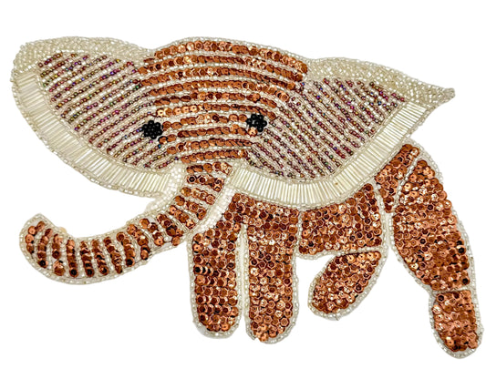 Decorative elephant patch with bronze sequins  and silver beads on a white background