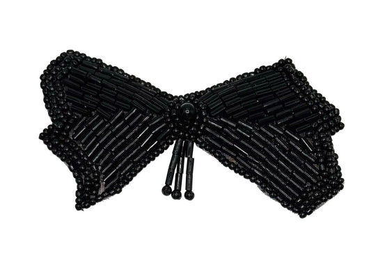 Black beaded bow on a white background