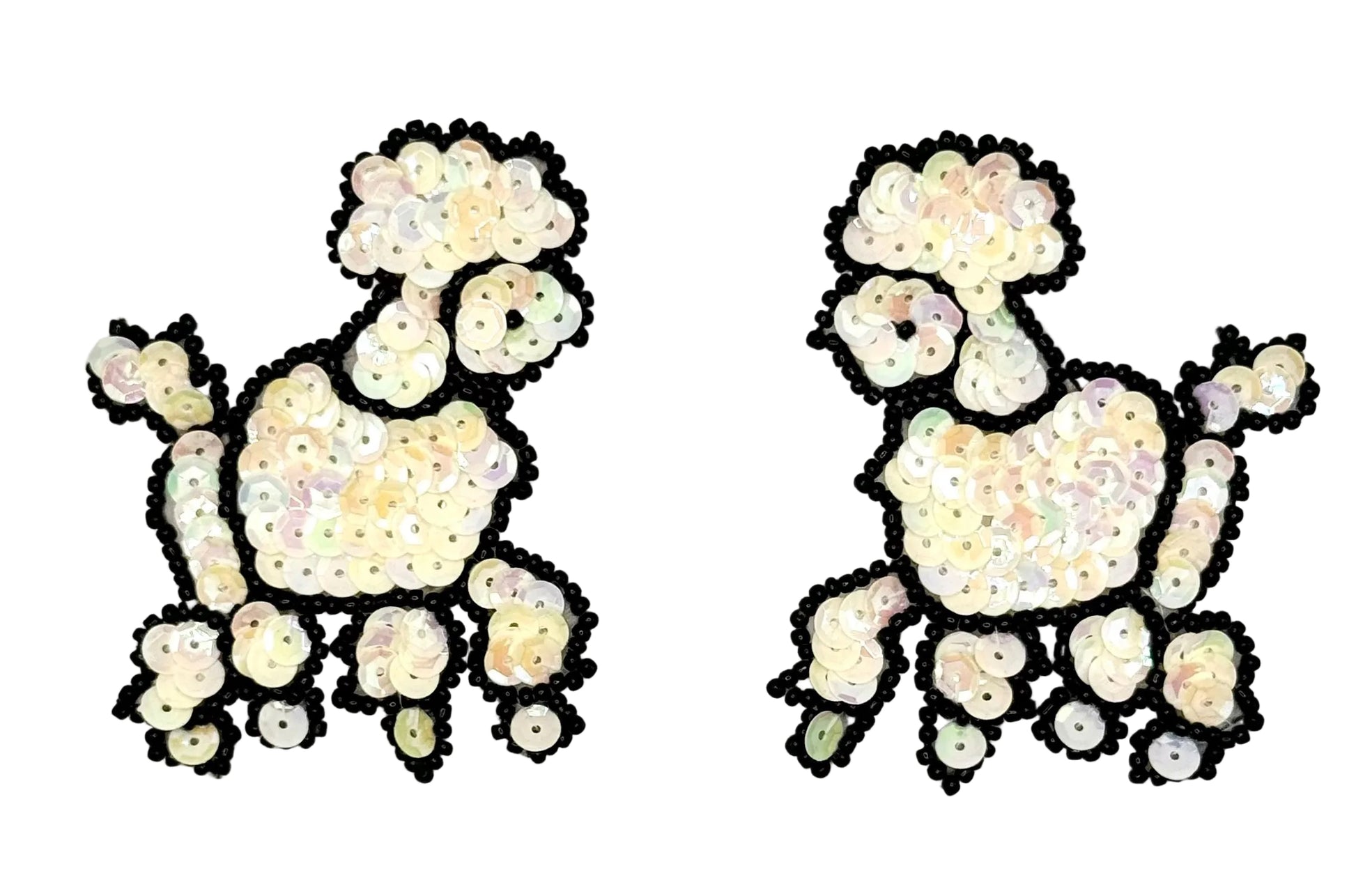 Pair of sequin poodles with iridescent cream sequins and black beads on a white background