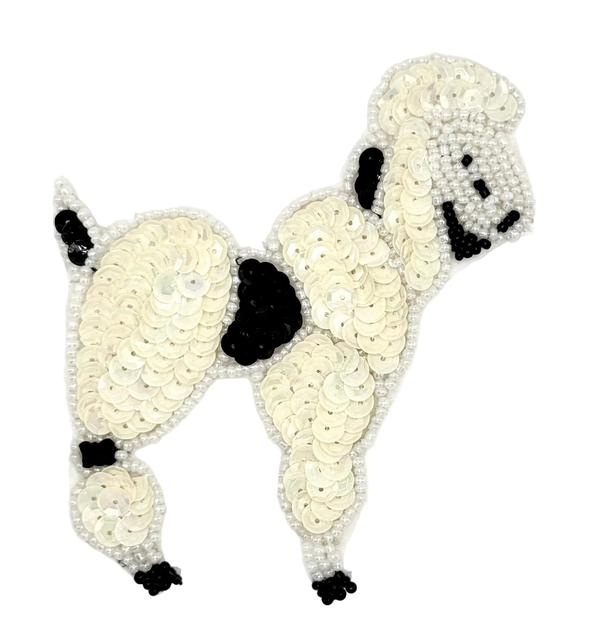 Cream colored sequin poodle dog with black accents on a white background