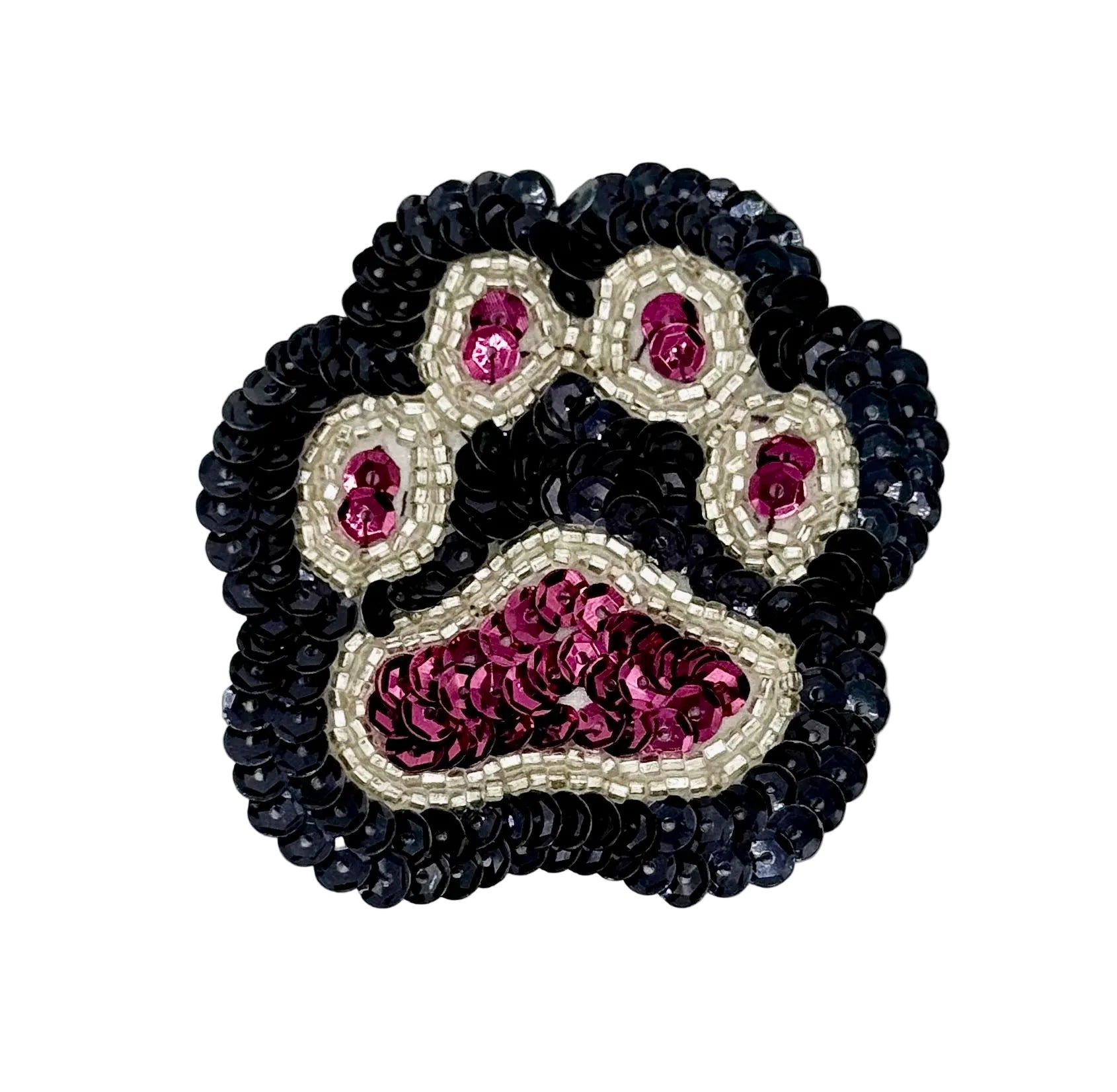 Paw print patch with  black, burgandy, and silver sequins and beads on a white background.