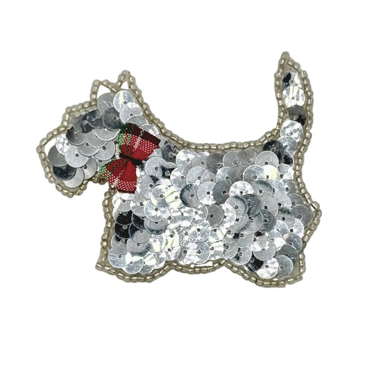 Sequined scottie dog patch with a red bow on a white background