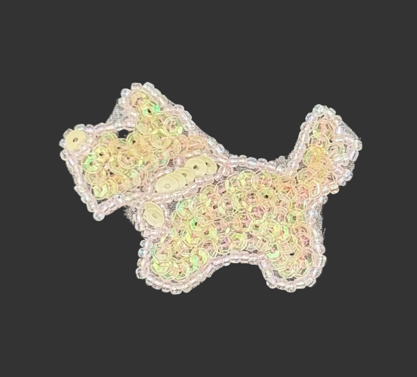 Sequined scottie dog patch on a gray background
