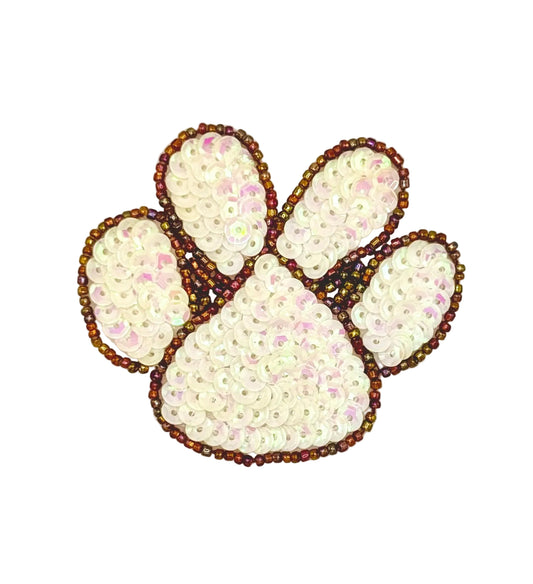 Decorative paw print with sequin and bead embellishments on a white background