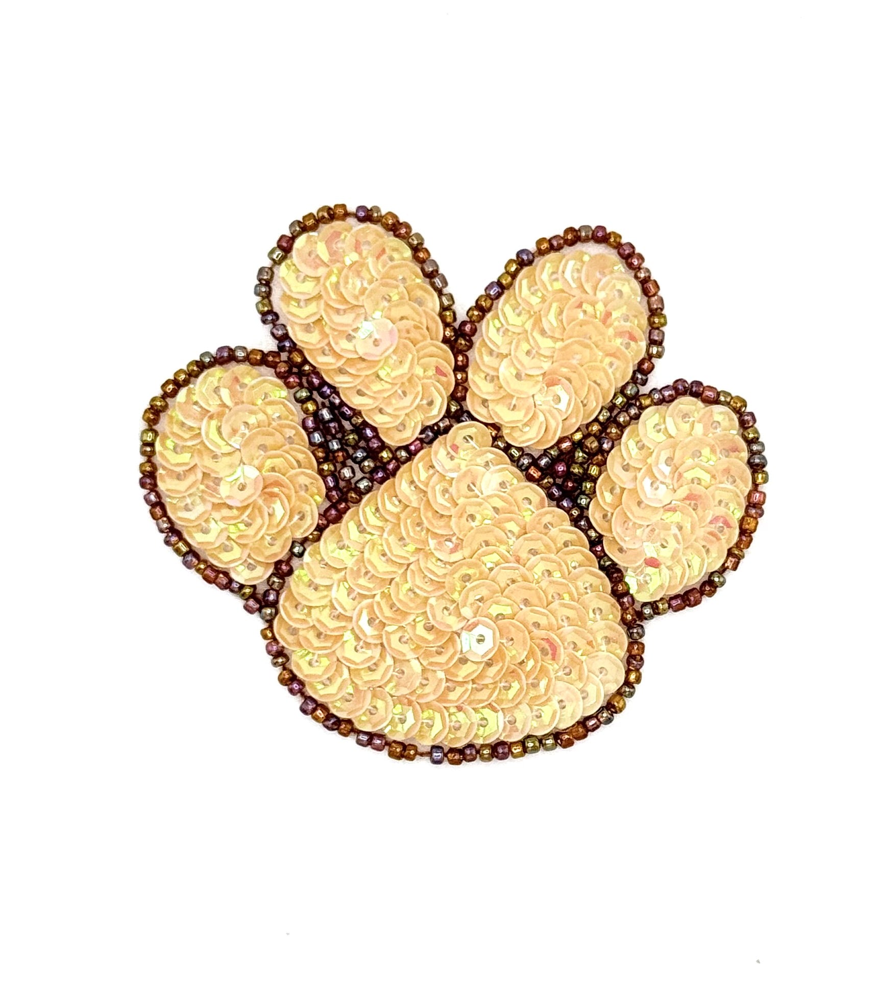 Decorative paw print with tan and brown sequins and beads on a white background