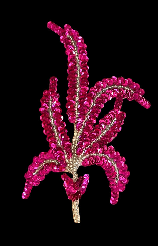 Fuchsia sequin floral design on a brown background
