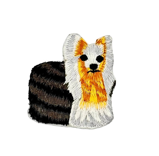Embroidered Yorkshire terrier patch of a dog with black, white, and orange colors on a white background