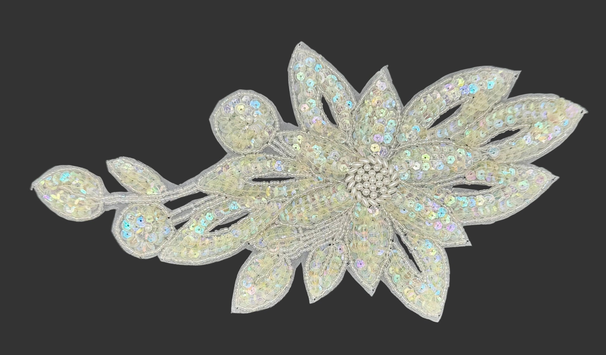 Decorative flower patch with sequins on a dark background