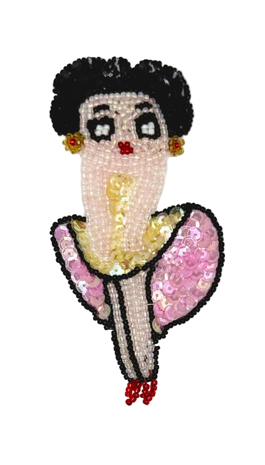 Vintage Sequin and bead cartoon character with a stylized face and pink sequin outfit on a white background