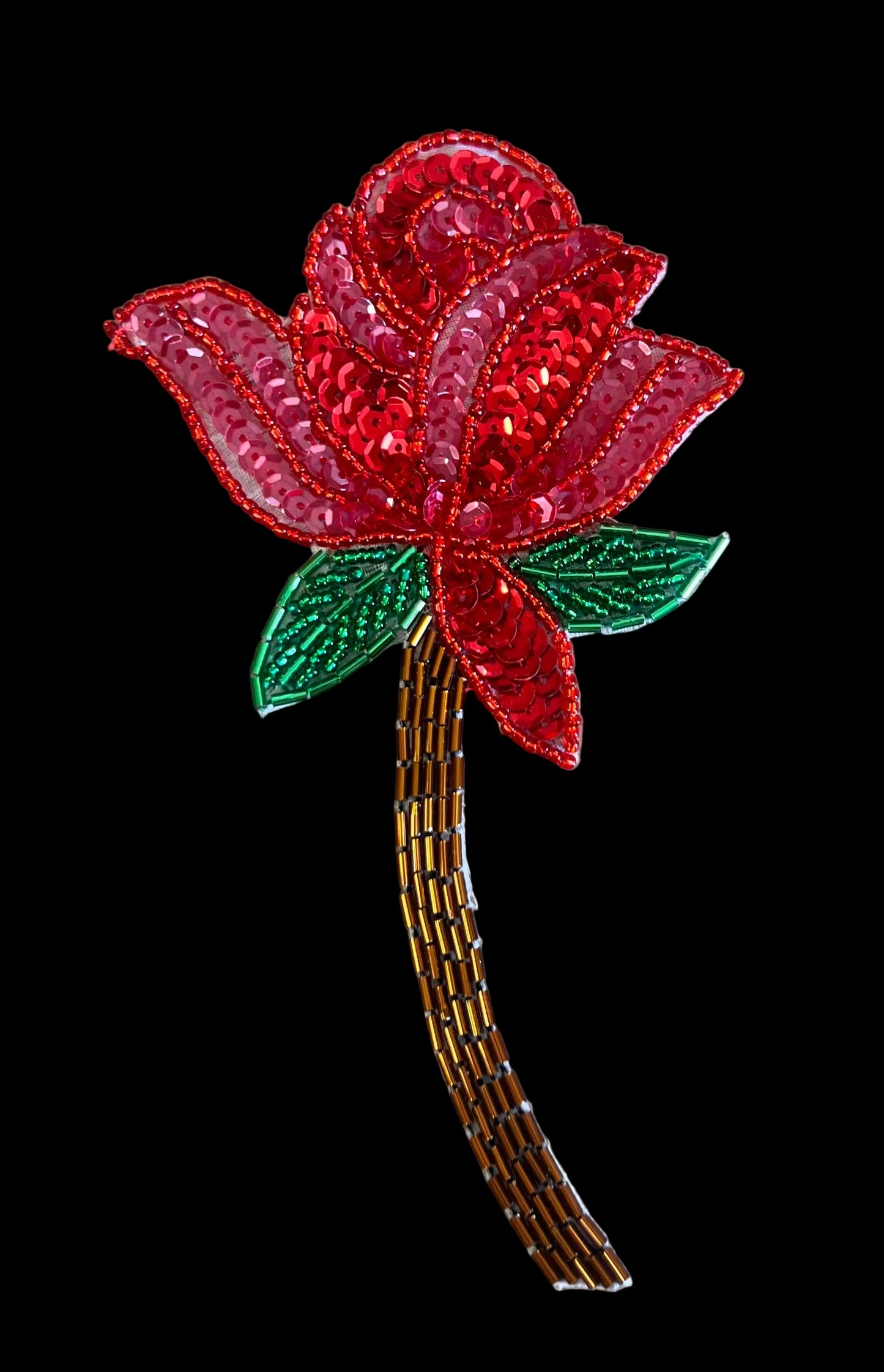 Decorative red rose with green leaves on a darkbackground