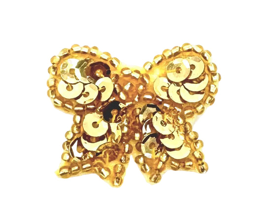 Gold bow with sequins and beads on a white background