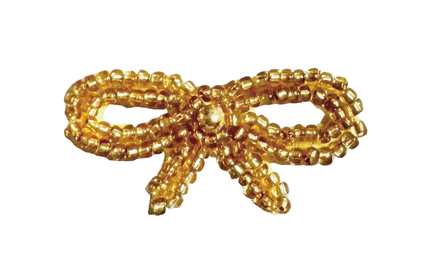 Gold beaded bow patch on a white background