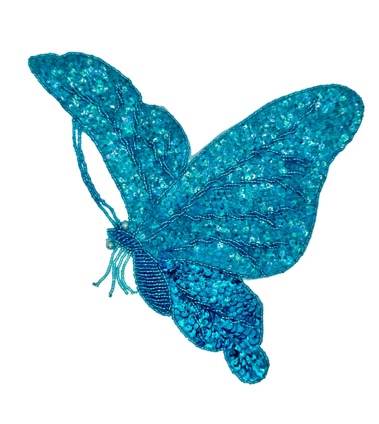 Turquoise sequin and bead butterfly in flight patch on a white background