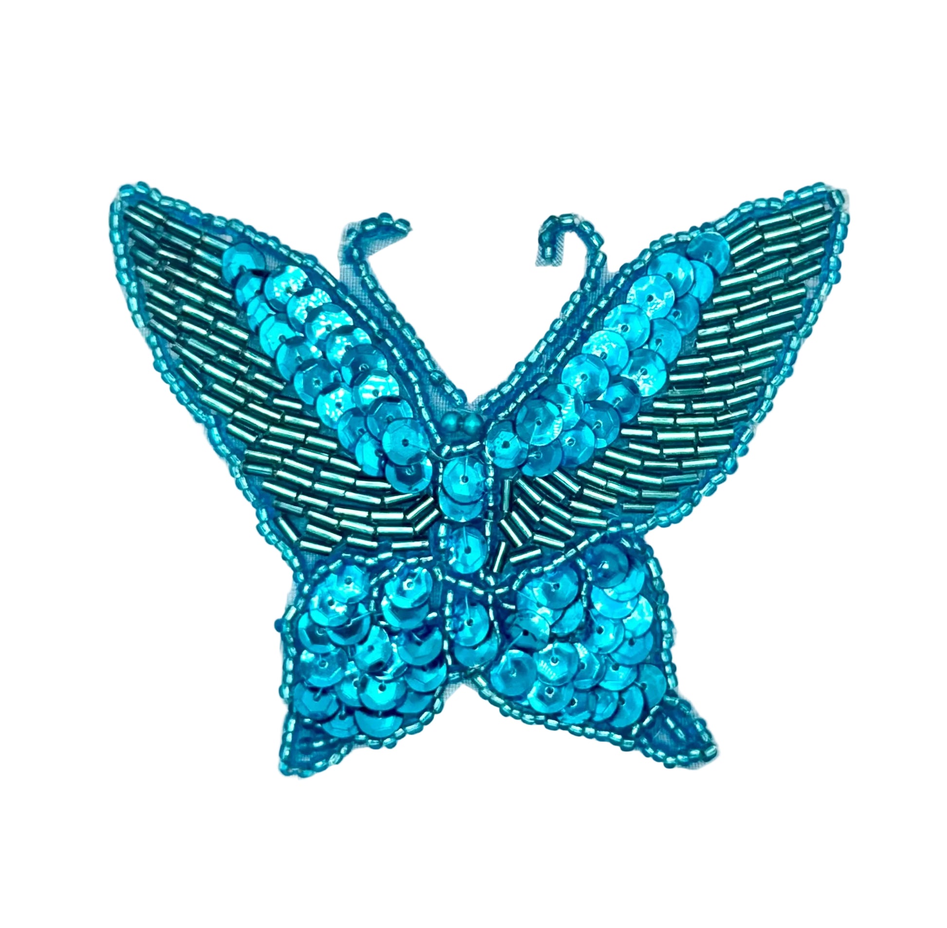 Turquoise butterfly with sequins and beads on a white background
