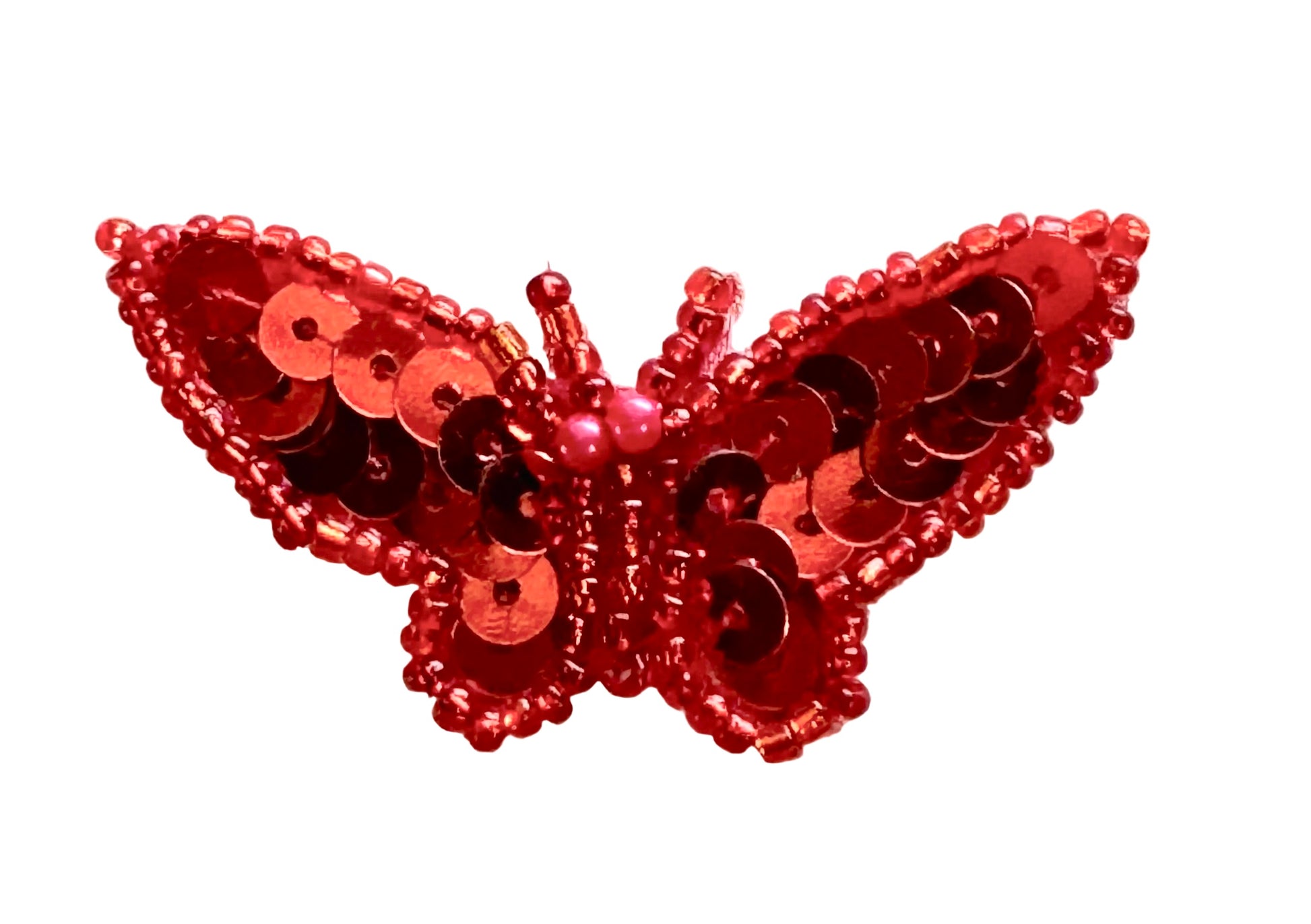 Red sequin butterfly on a white background
