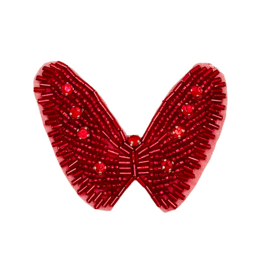 Red butterfly-shaped decorative item with rhinestones on a white background