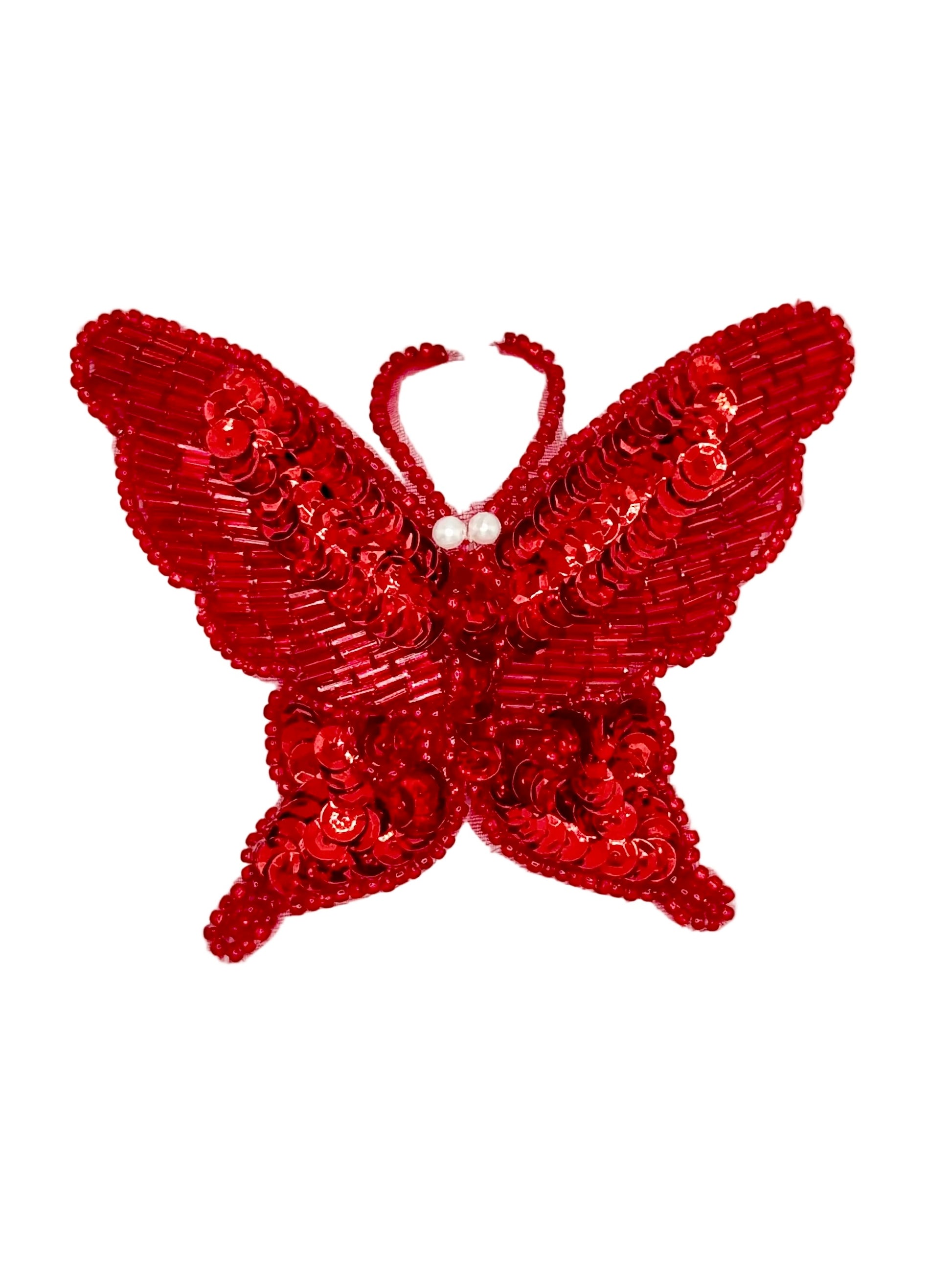 Red butterfly-shaped accessory with sequins on a white background
