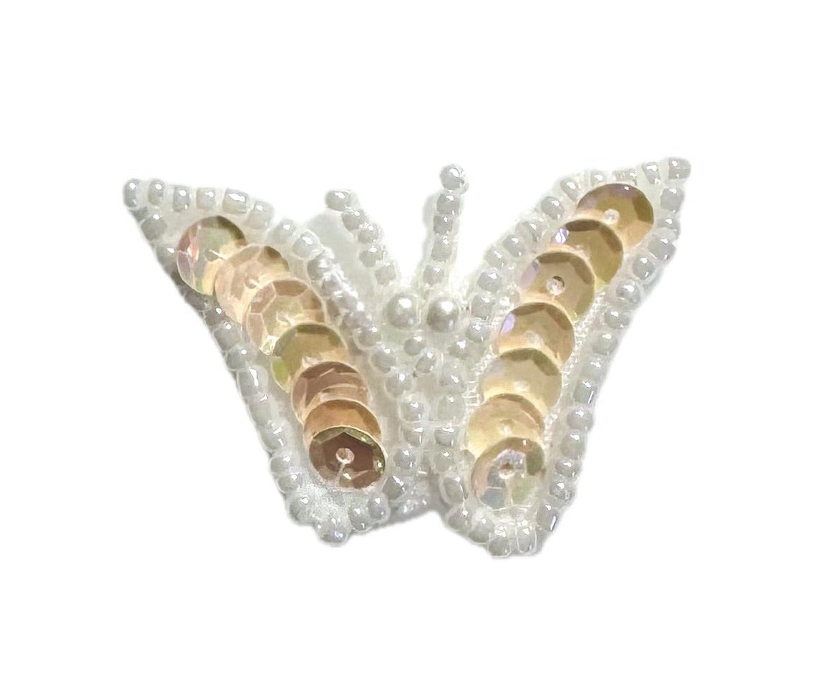 Butterfly patch with iridescent beige sequins and white beads on a white background with 