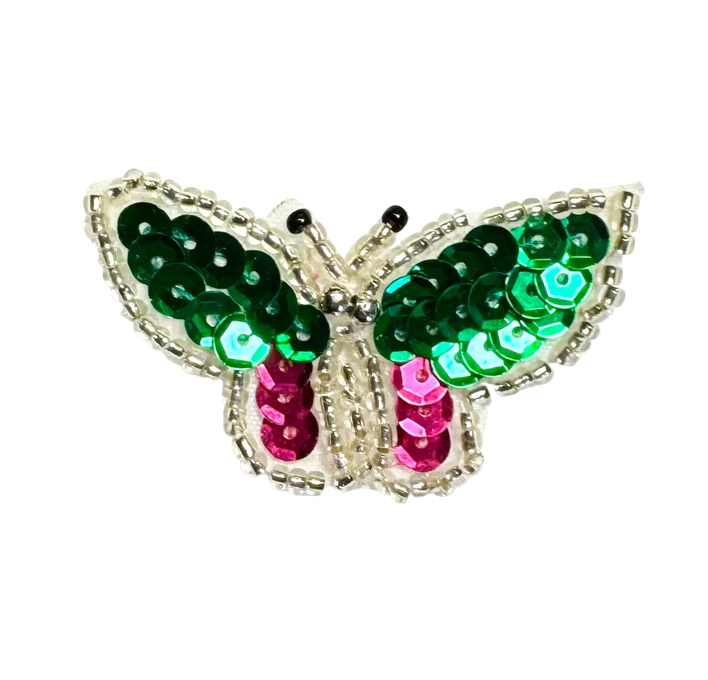 Butterfly-shaped decorative item with green and pink sequins on a white background