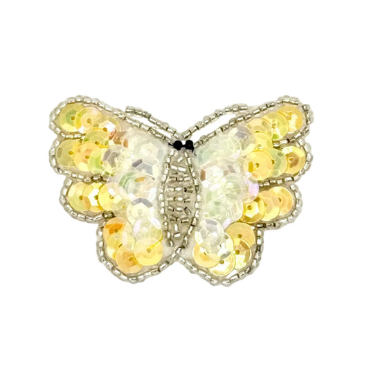 Butterfly-shaped decorative item with yellow sequins on a white background