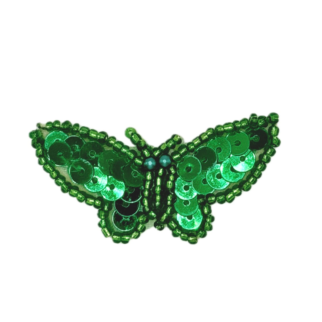 Green butterfly-shaped decorative item with sequins on a white background