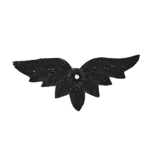 Black feathered patch with a central rhinestone on a white background