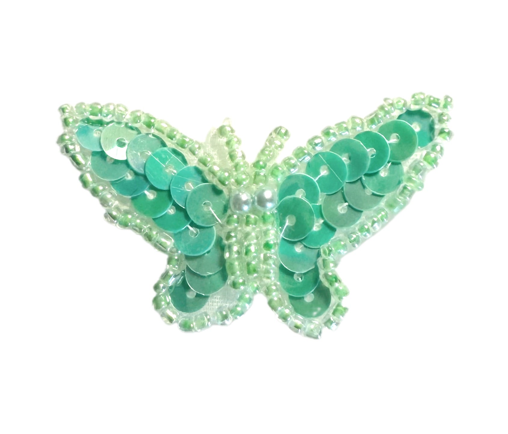 Green butterfly with sequins and beads on a white background