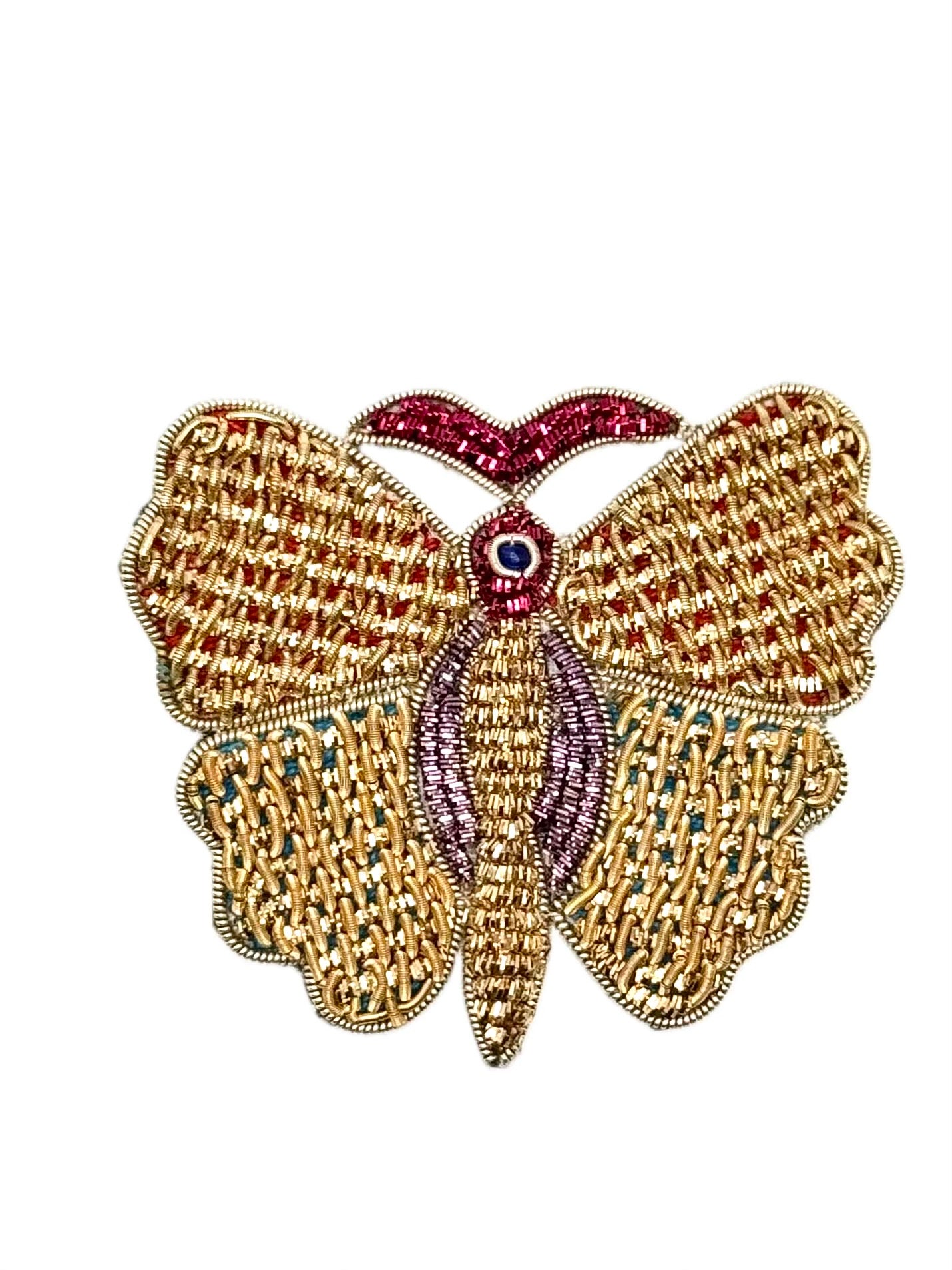 Decorative butterfly with gold wings and red and purple accents on a white background