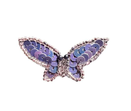 Butterfly-shaped patch with lavender sequins on a white background