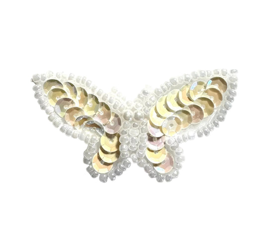 Butterfly-shaped patch with Iridescent cream sequins on a white background