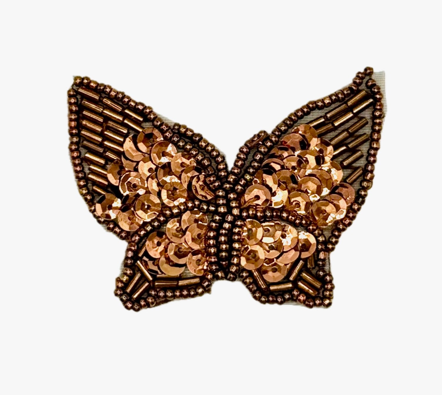 Decorative butterfly with bronze sequin details on a white background