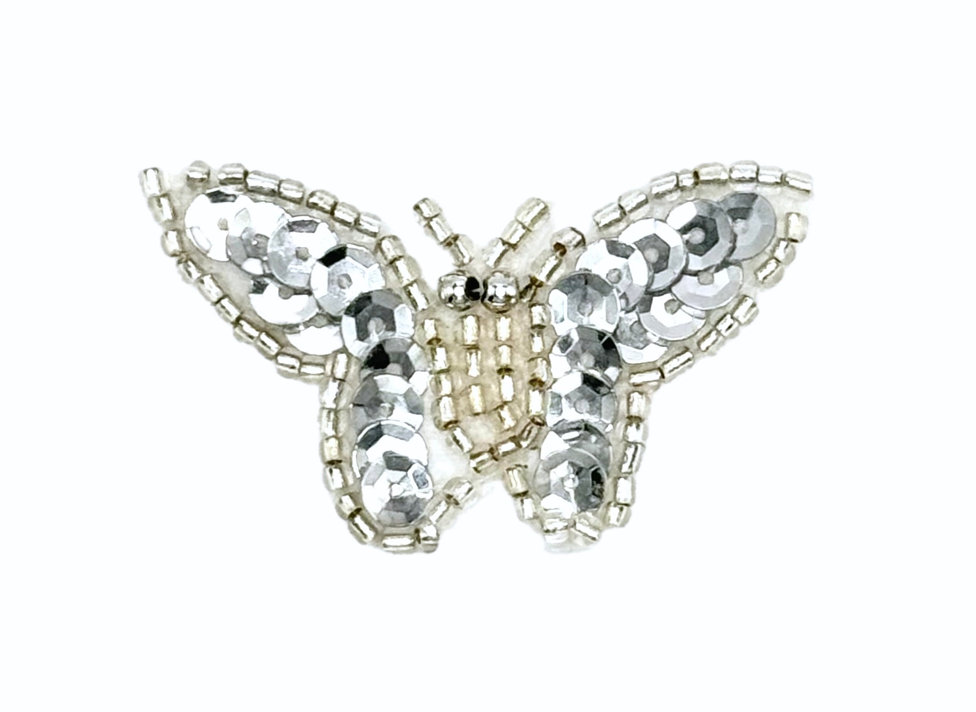 Butterfly-shaped decorative item with sequins on a white background