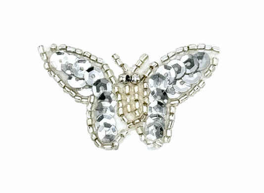 Butterfly-shaped decorative item with sequins on a white background