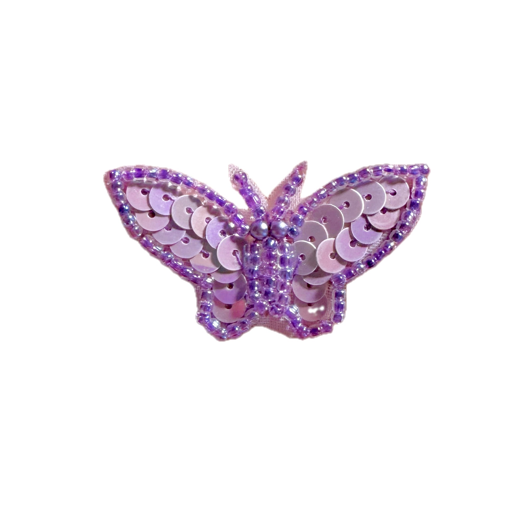 Butterfly-shaped patch with purple sequins on a white background