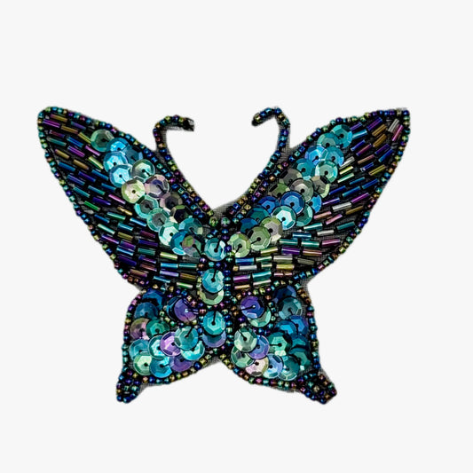 Decorative butterfly with sequins and beads on a white background