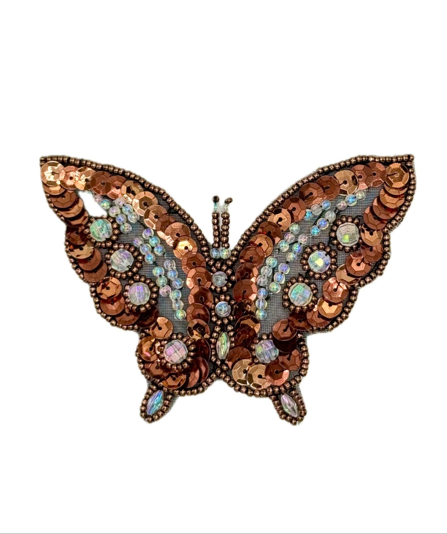 Butterfly-shaped decorative item with sequins and beads on a white background