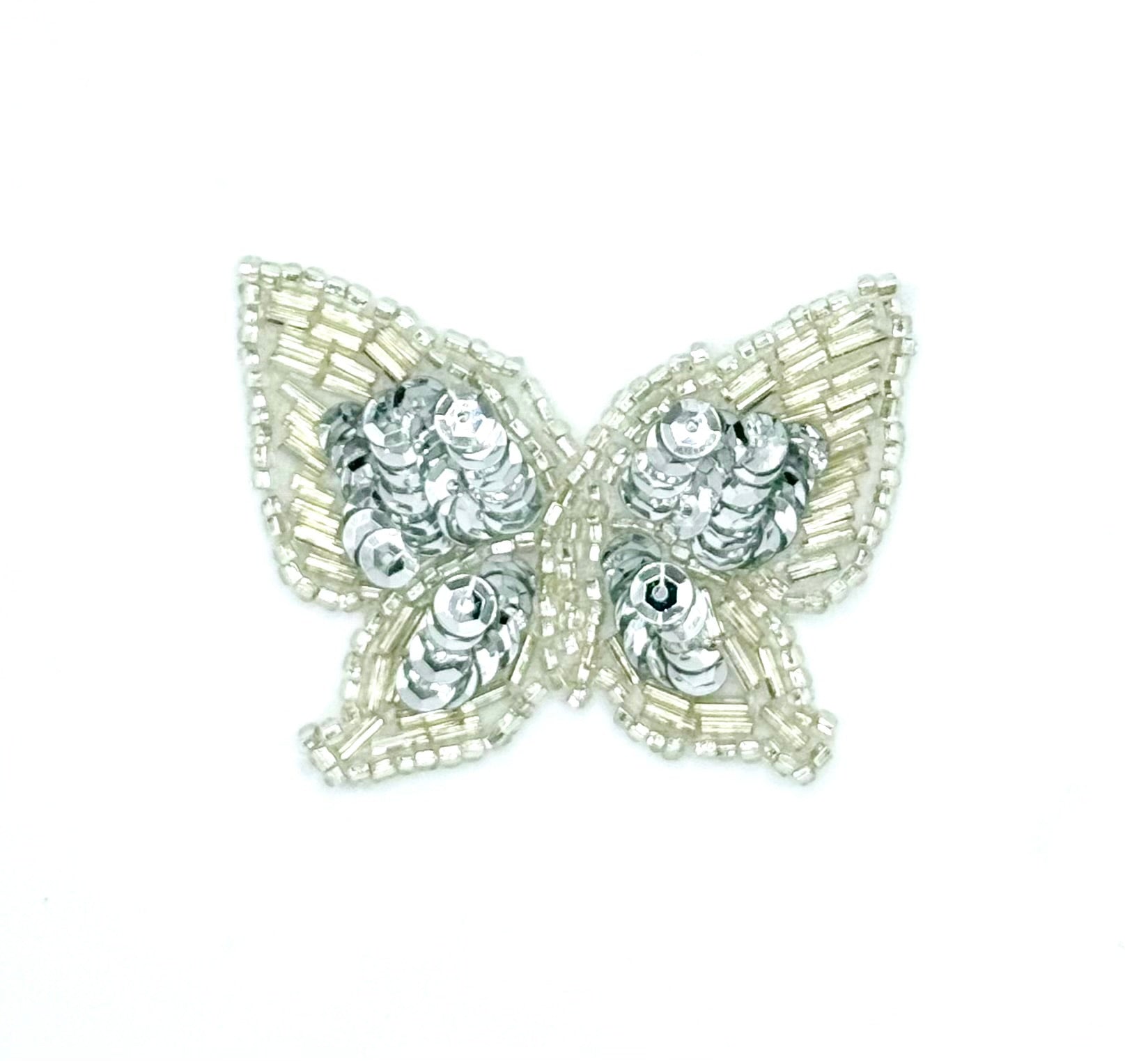 Butterfly-shaped patch with silver beads and sequins on a white background