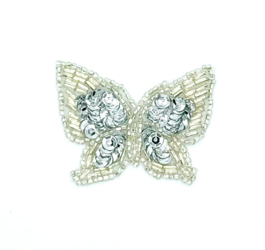 Butterfly-shaped patch with silver beads and sequins on a white background