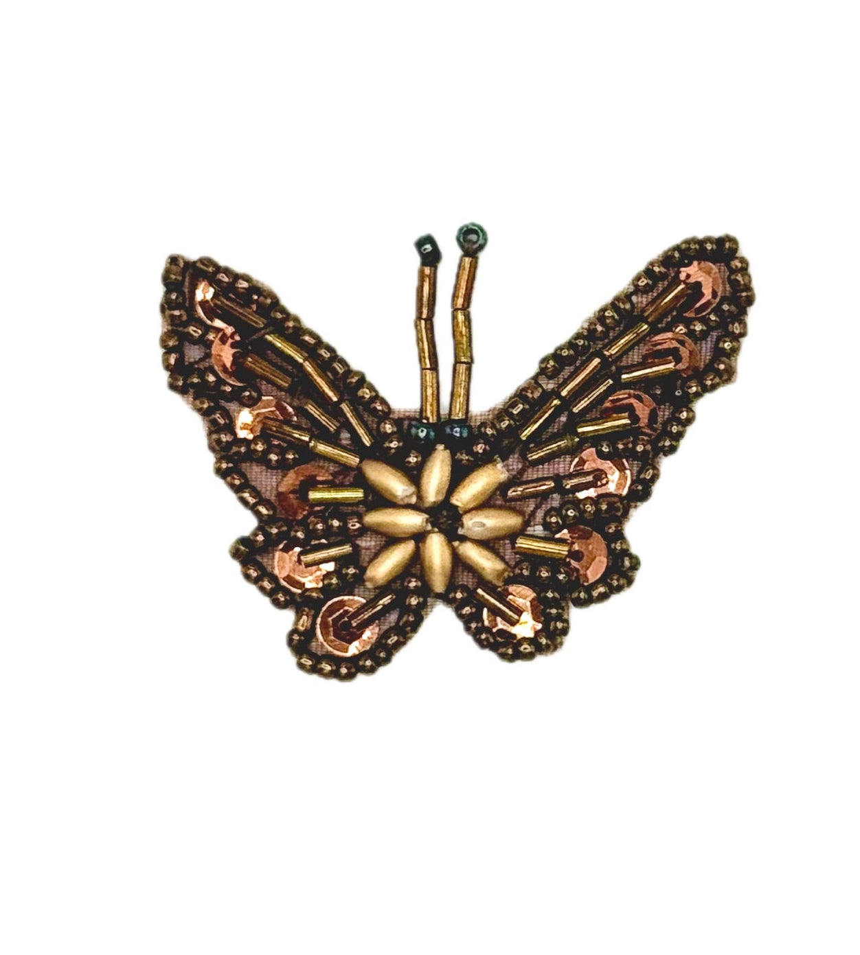 Decorative butterfly pin with intricate design on a white background